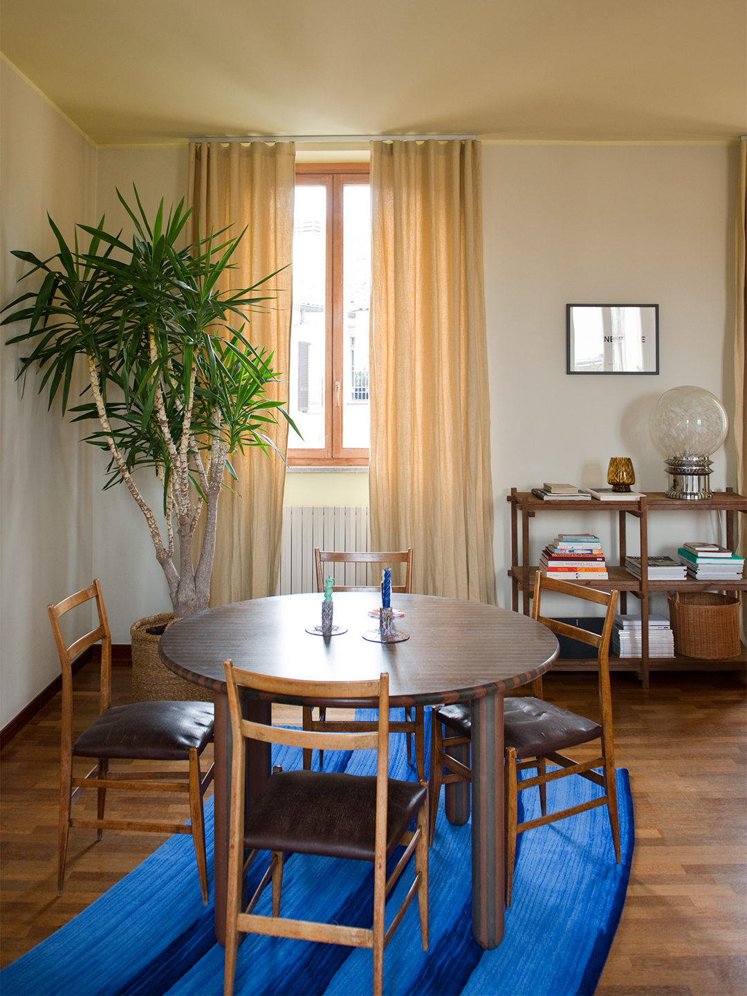 wood table and chairs on cobalt rug