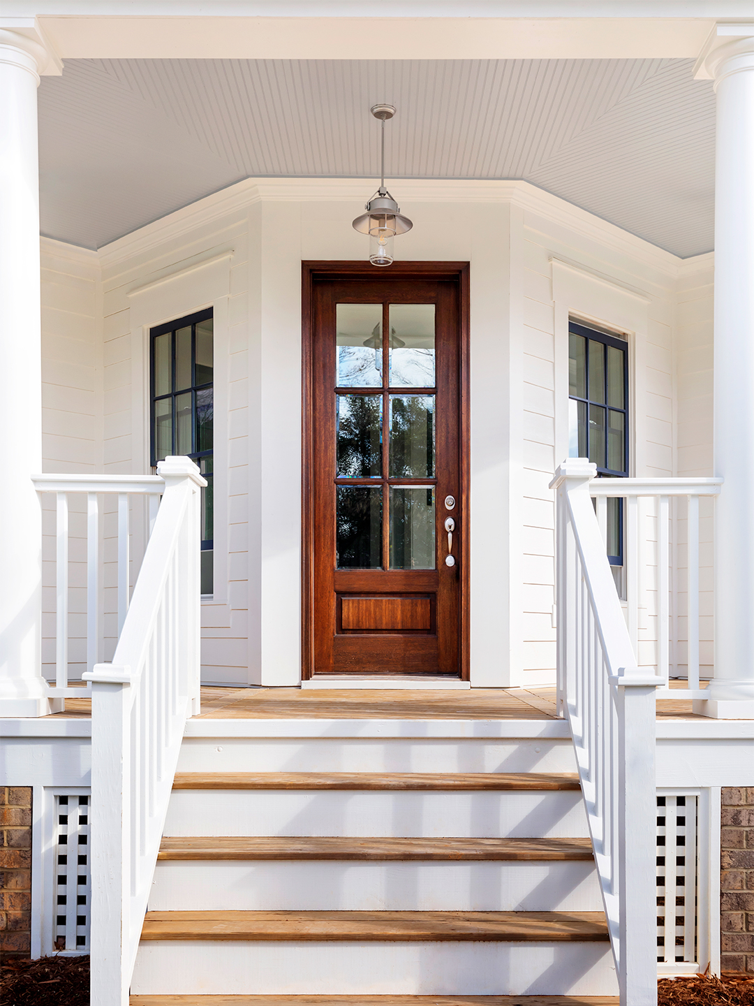 exterior of white home with brown door