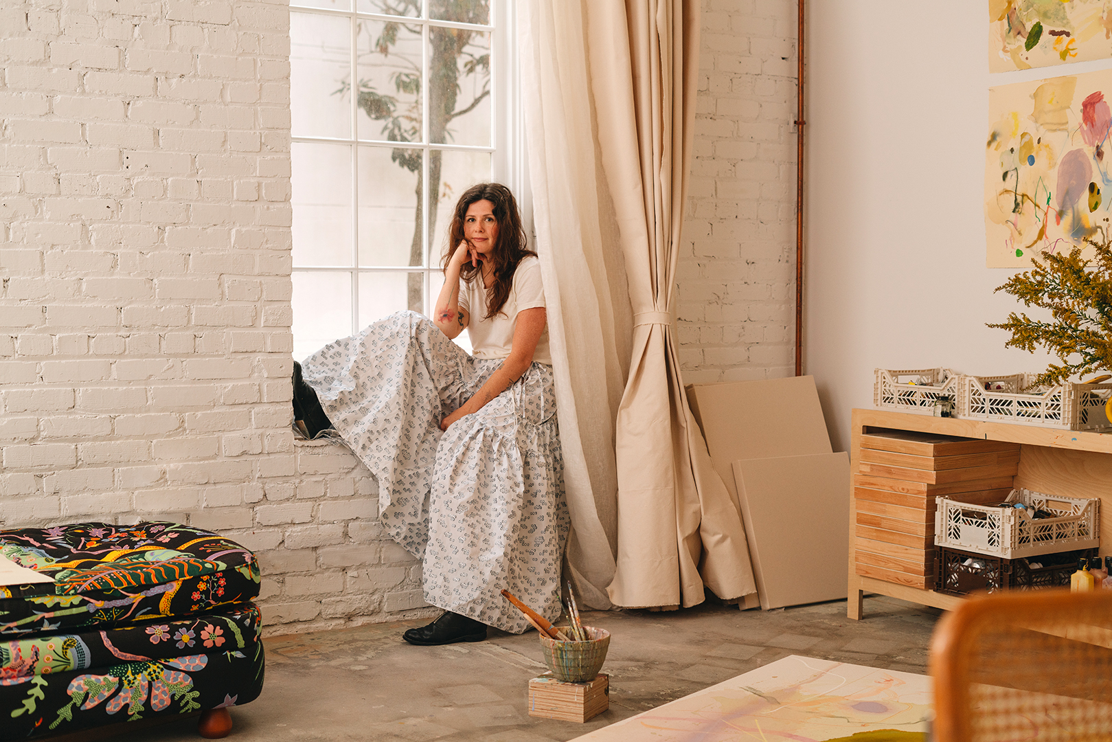 artist sitting in studio window