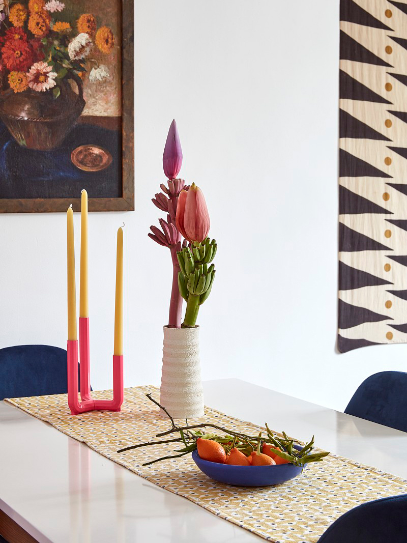 pink taper candle and fruit bowl