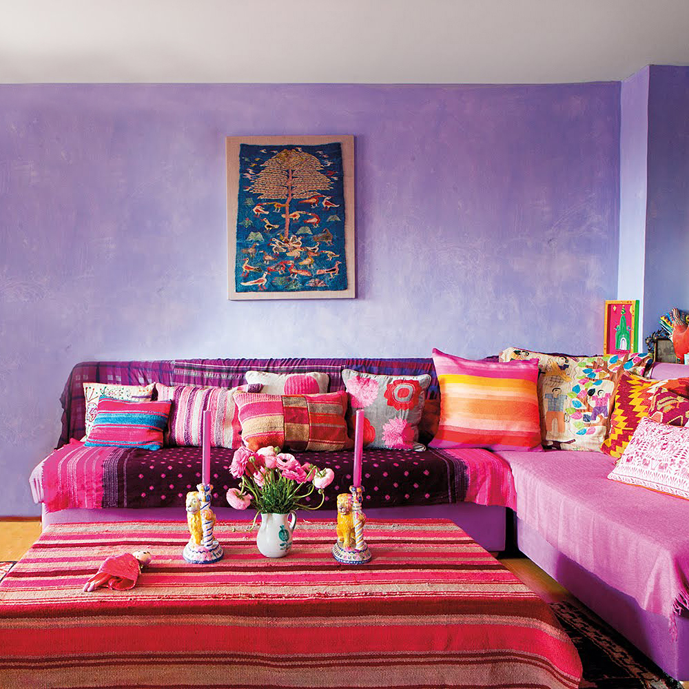 Purple walls and a red sofa