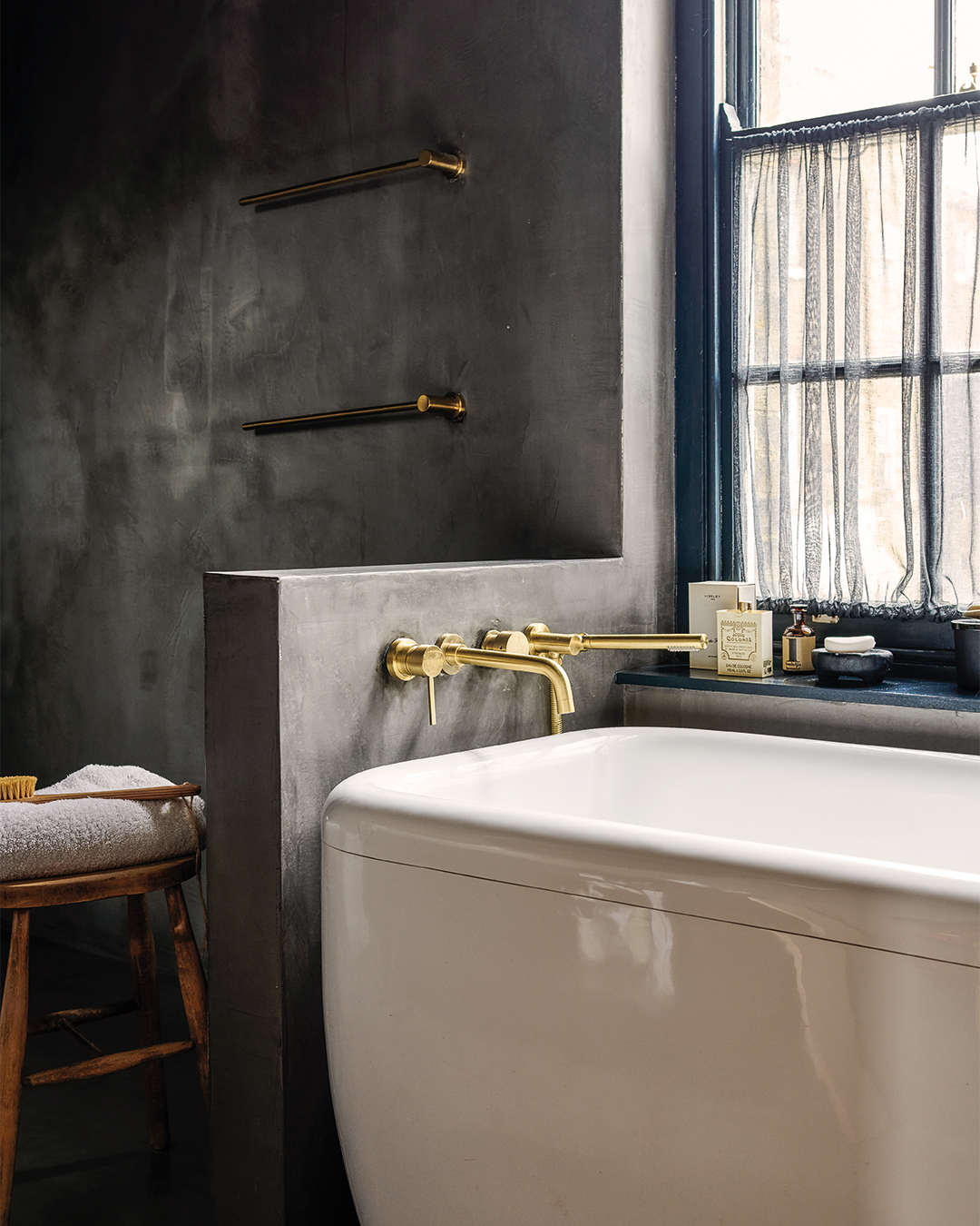 tub in dark gray plastered bathroom