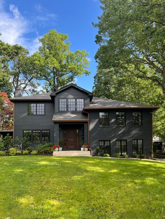 Home with dark exterior and copper gutters