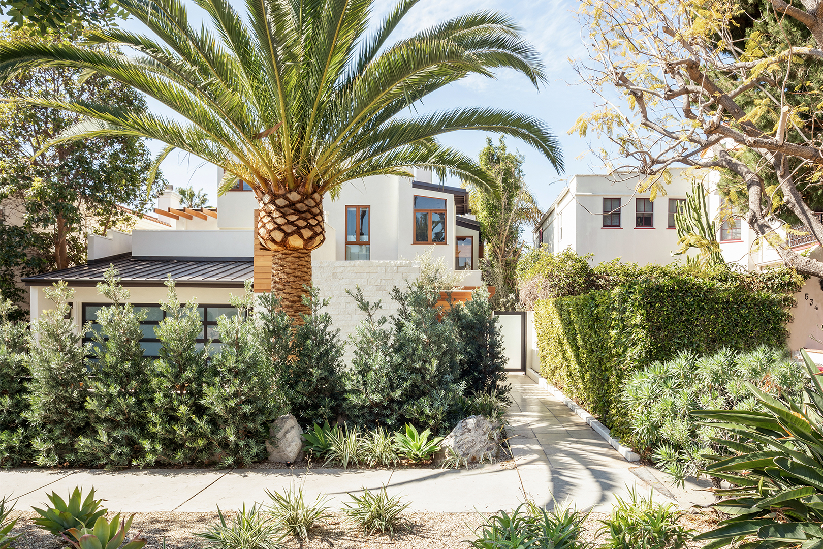 Home with palm trees and white exterior