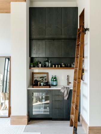 Black kitchen cabinets with a ladder