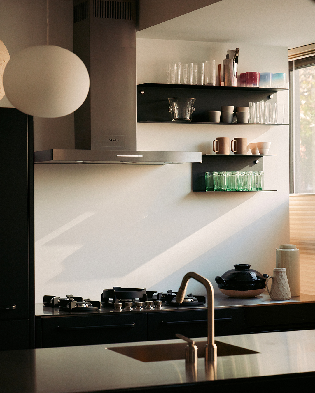 steel hood over integrated cooktop