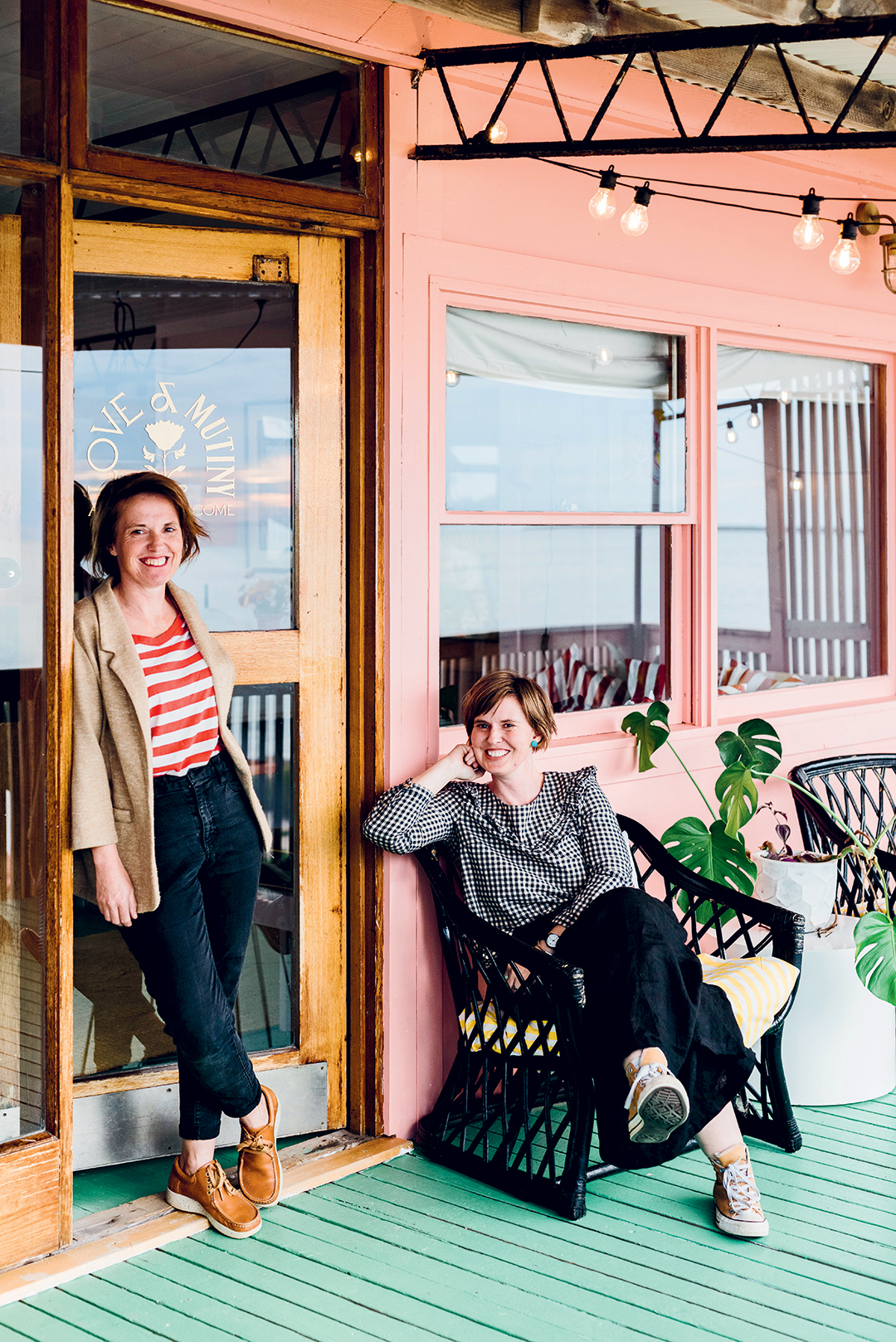 Two sisters on the porch of their beach shack