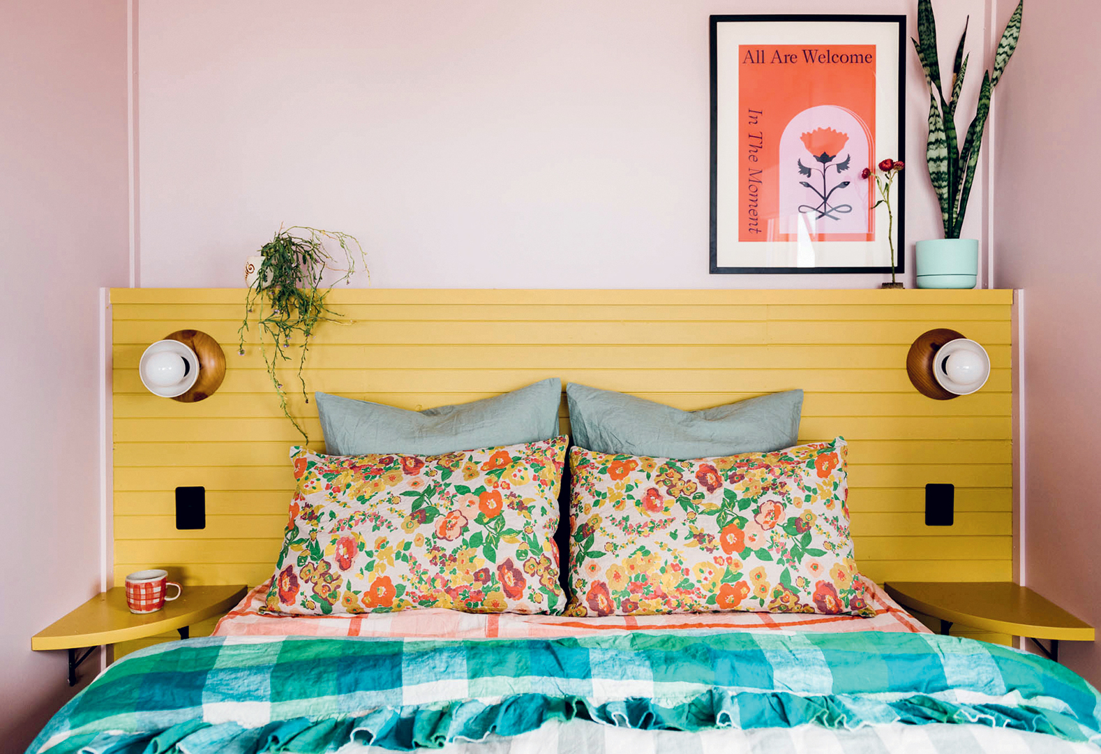 Bed with yellow headboard and colorful bedding
