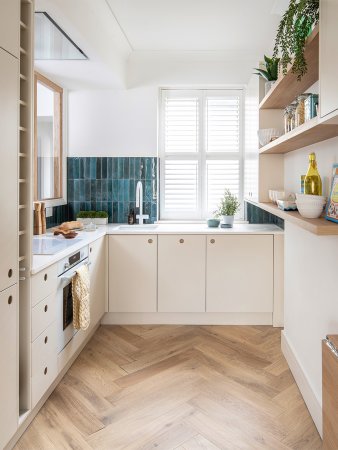 small cream-colored kitchen with turquoise tile