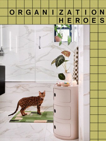 marble bathroom with freestanding storage and cat