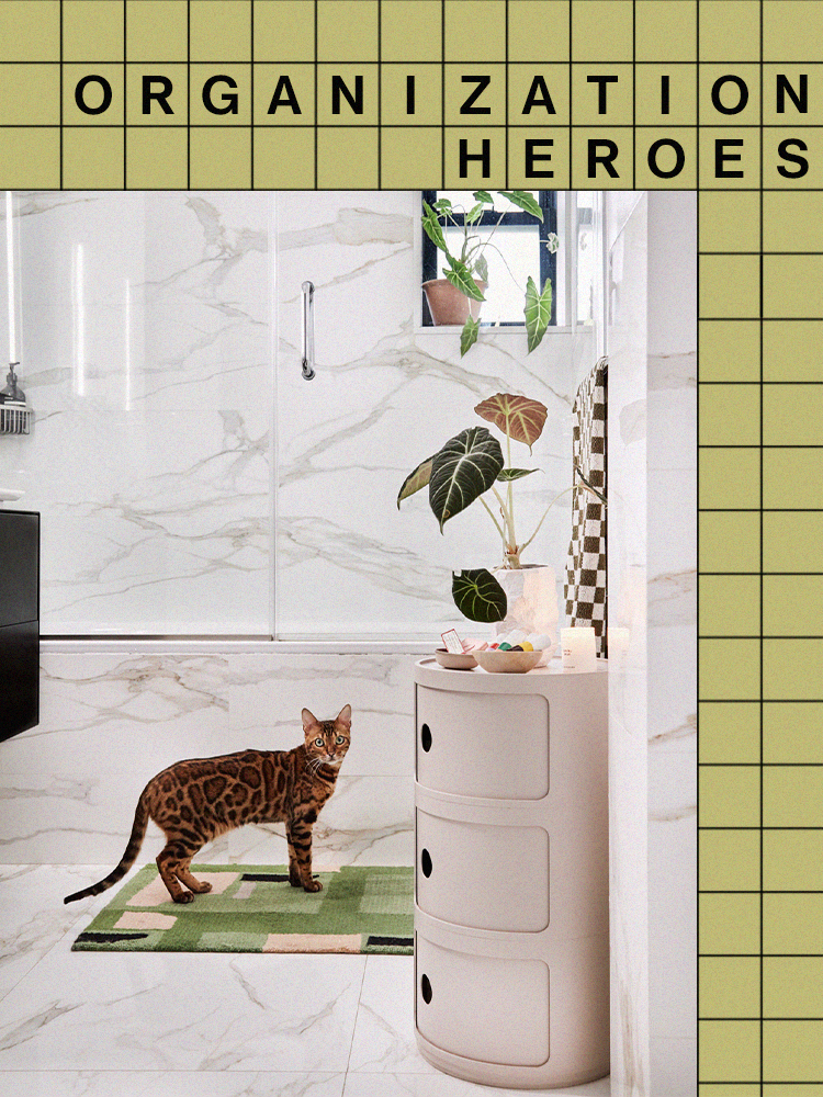 marble bathroom with freestanding storage and cat