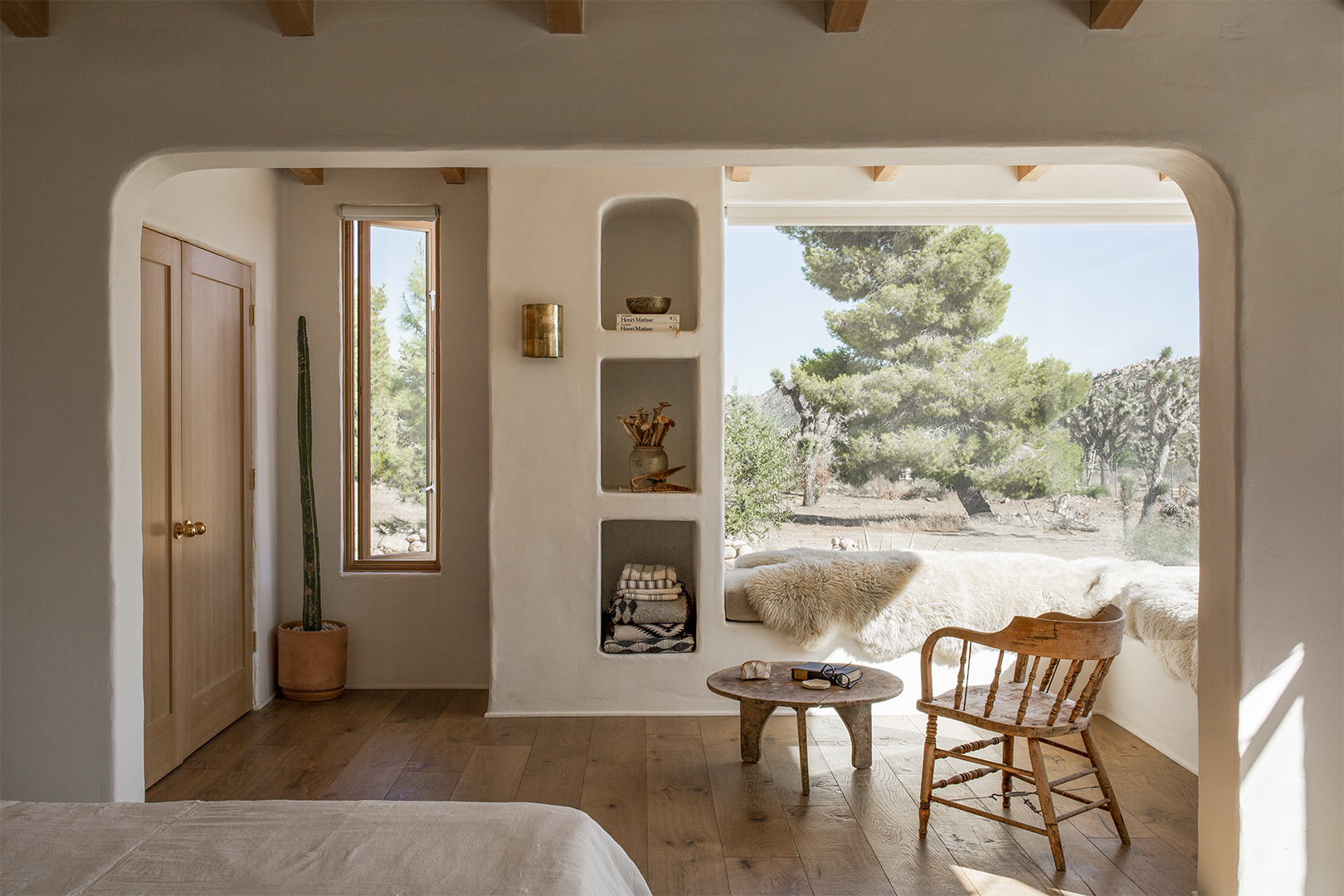 minimalist white living room looking out on dessert