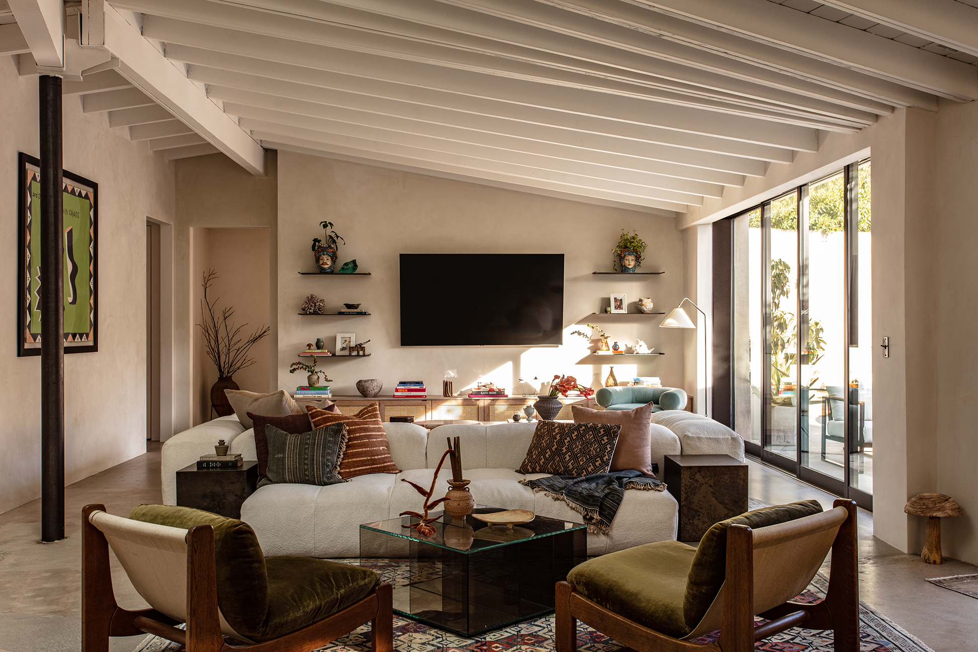 Living room with large windows, divided by sofas