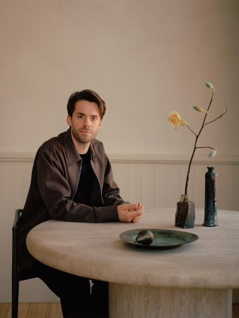 Colin King sitting wearing a brown jacket