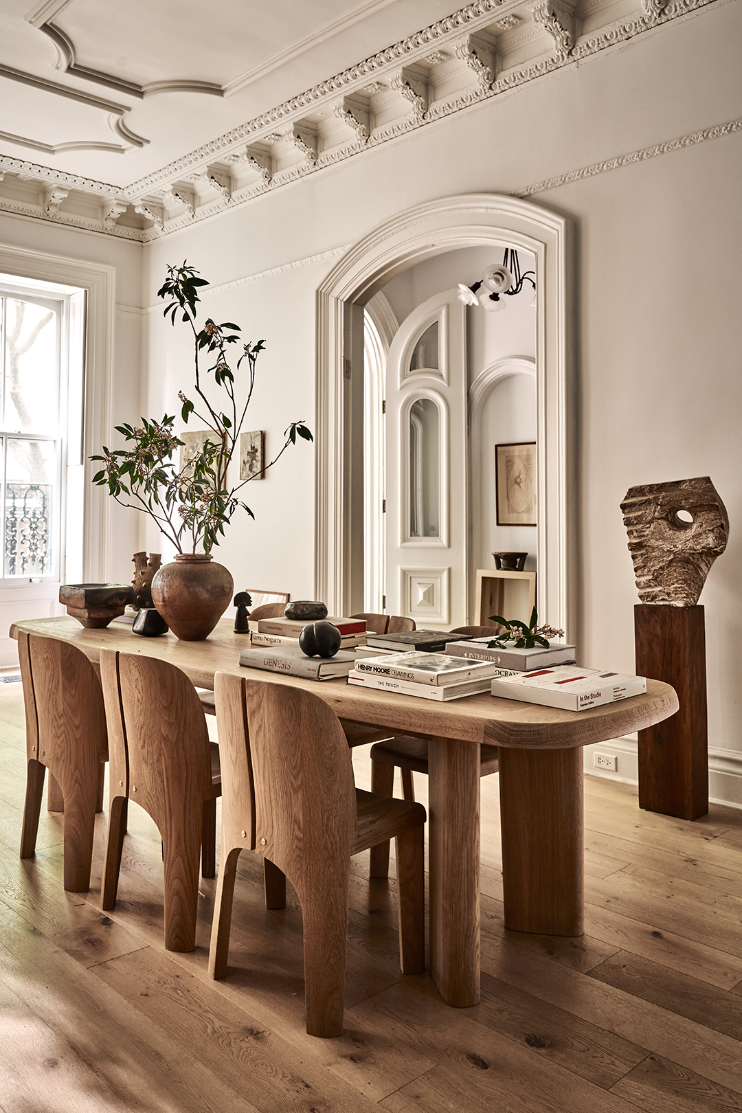 Dining room table with vase and branches