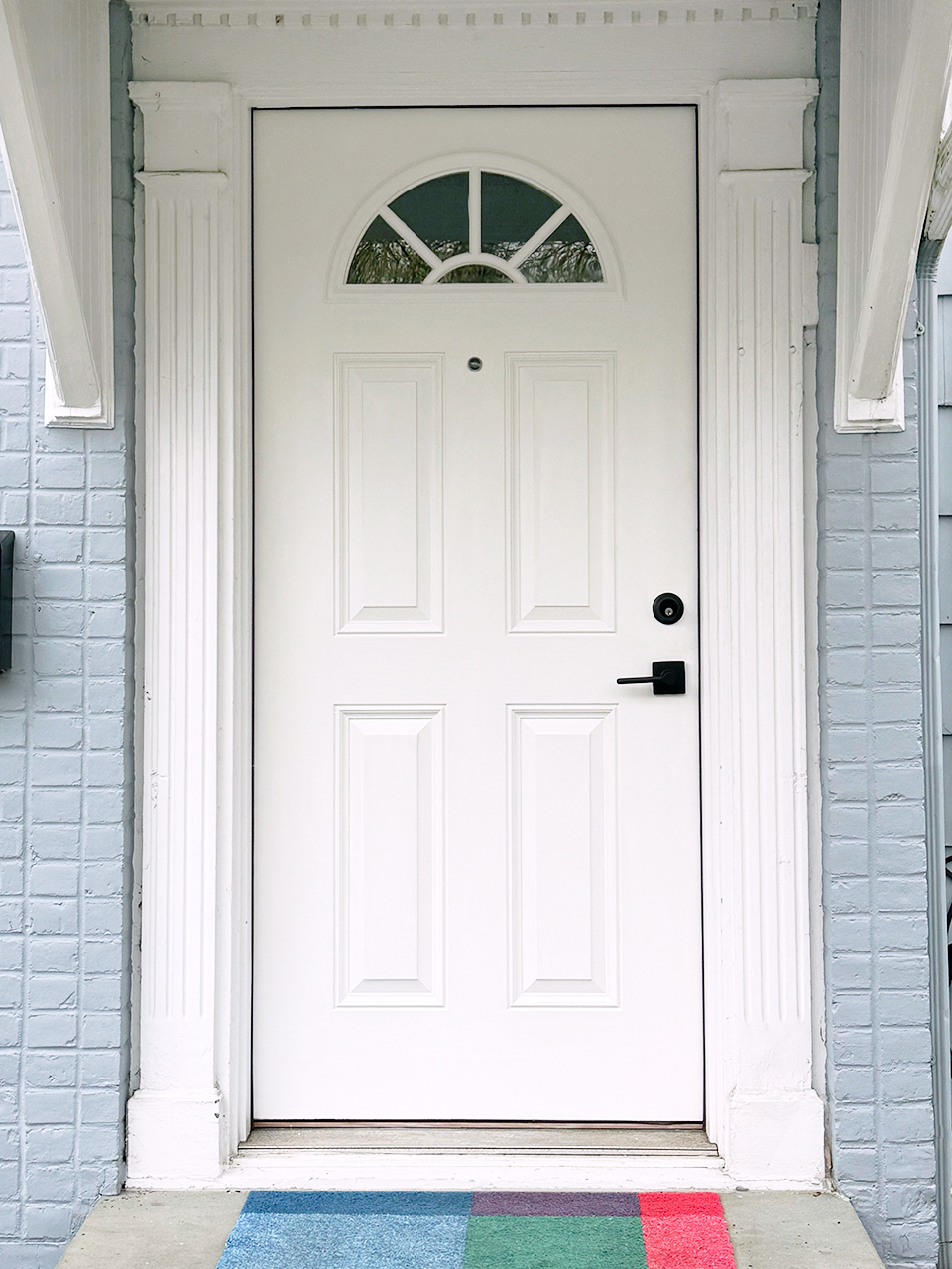 white front door with level lock