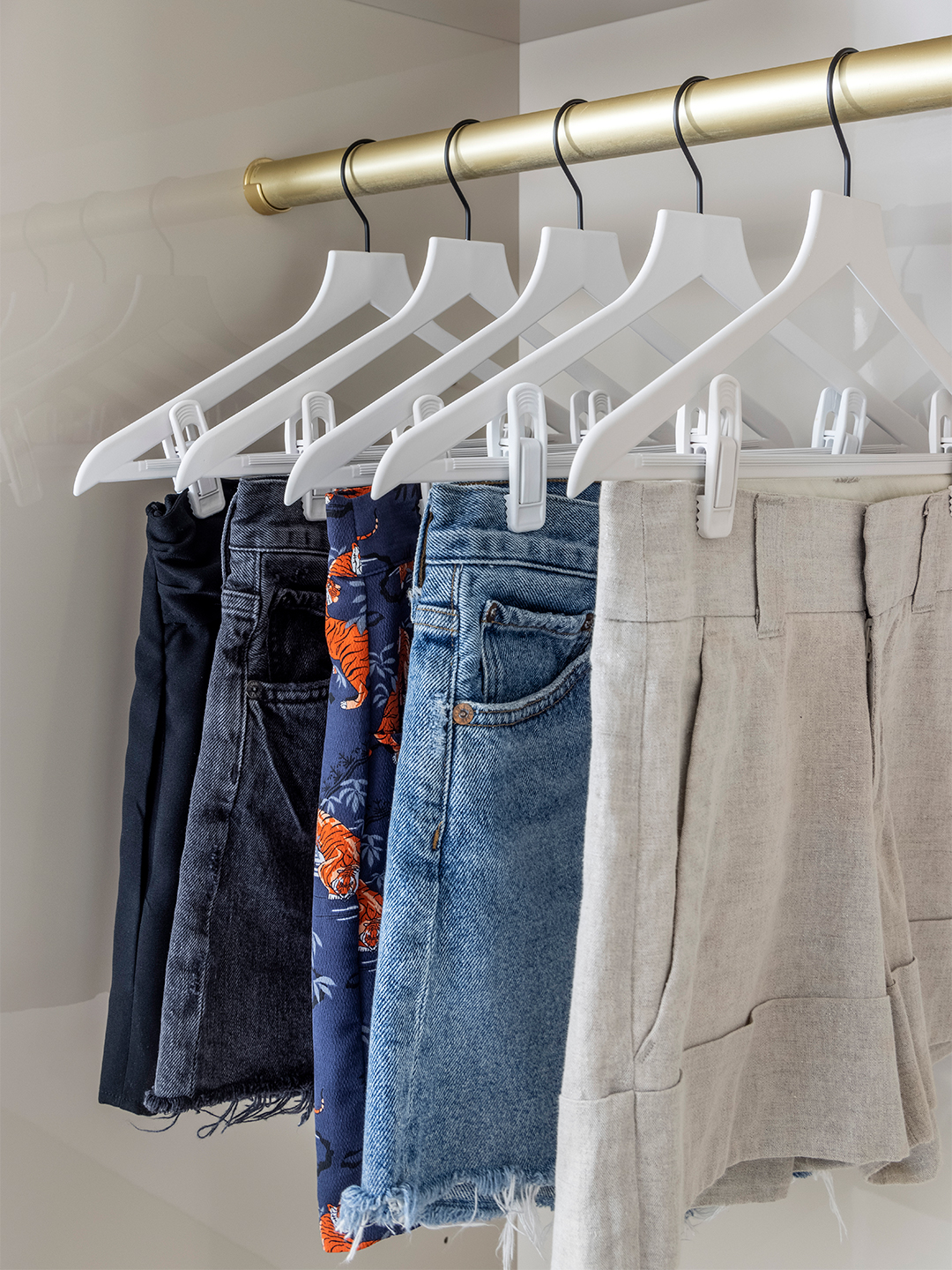 Closet with white hangers with clips