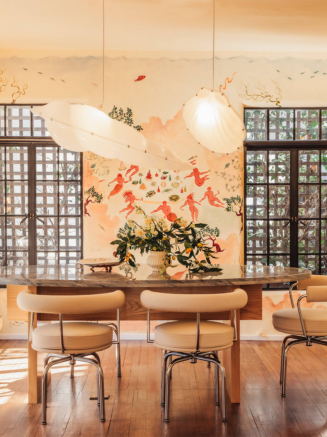 Ghia dining room with mural of trees and dancing characters