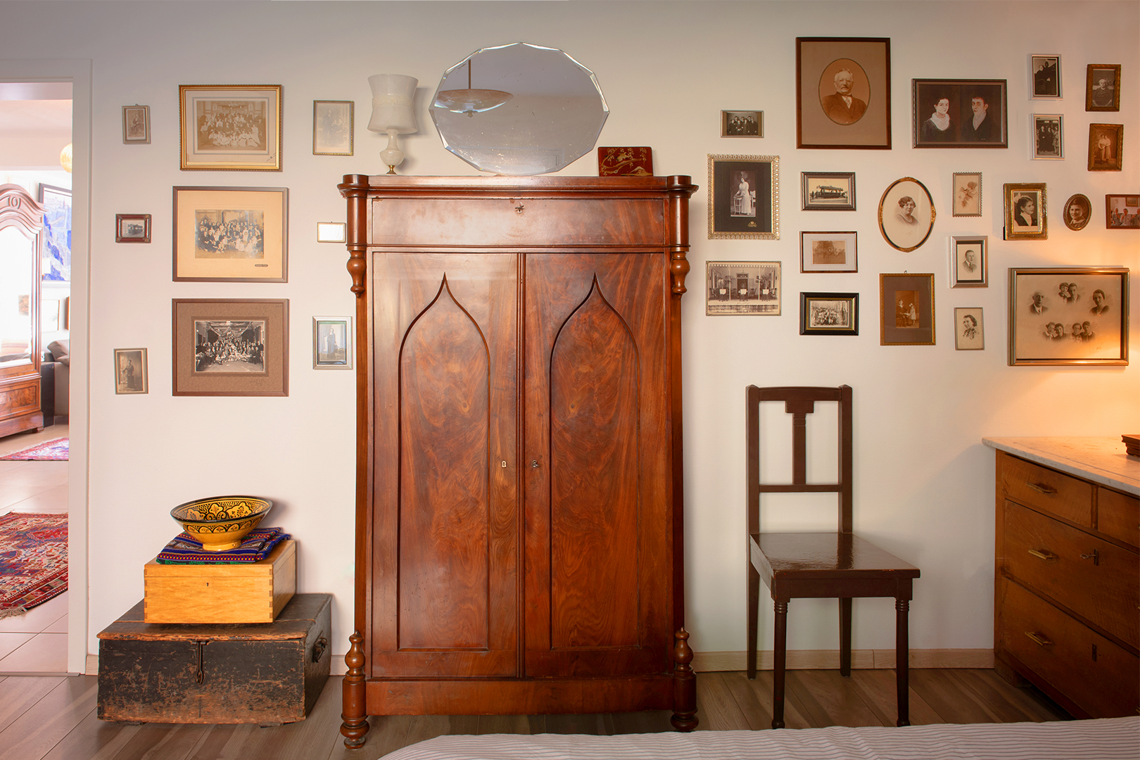 wood armoire with photos around it