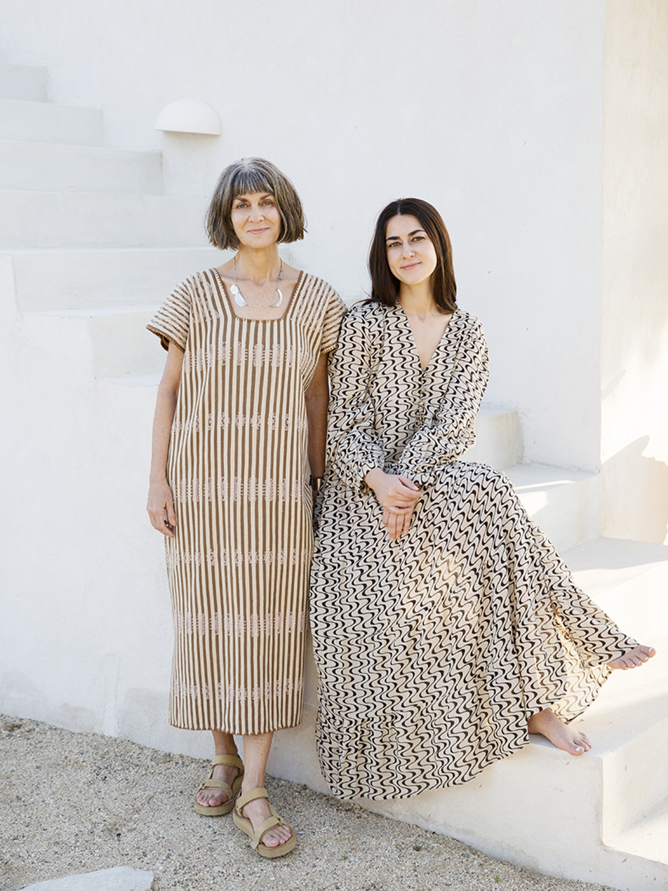 two women in dresses on exterior stairs