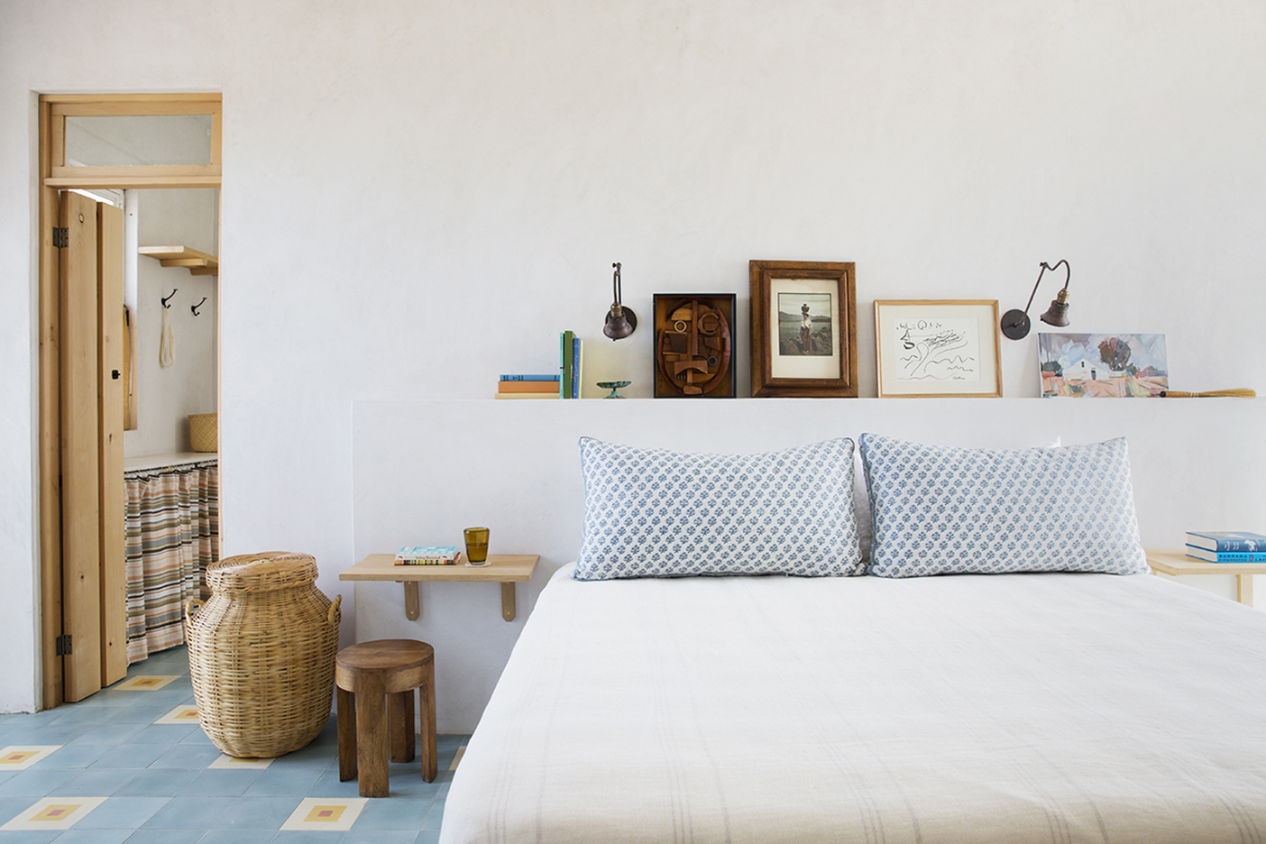 primary bedroom with built-in shelf as headboard