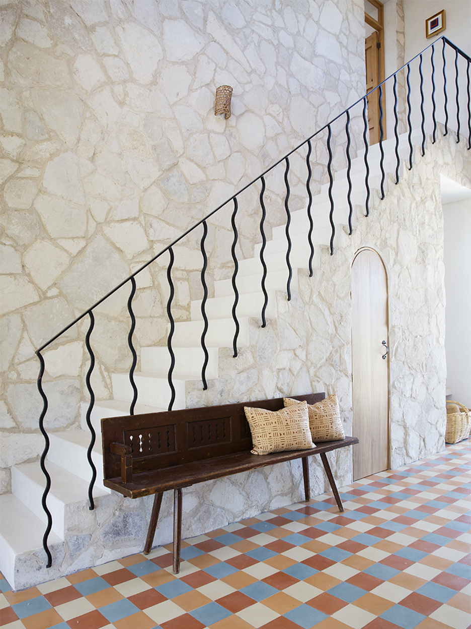 stairway with wavy bannister and checkered floor