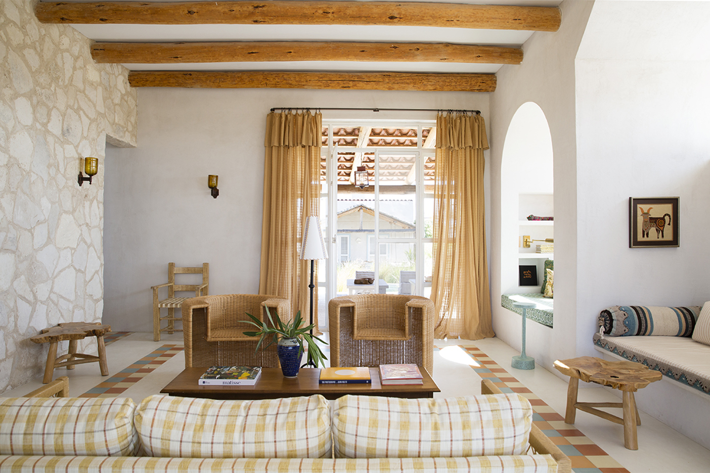 living room with wicker chairs and plaid sofa