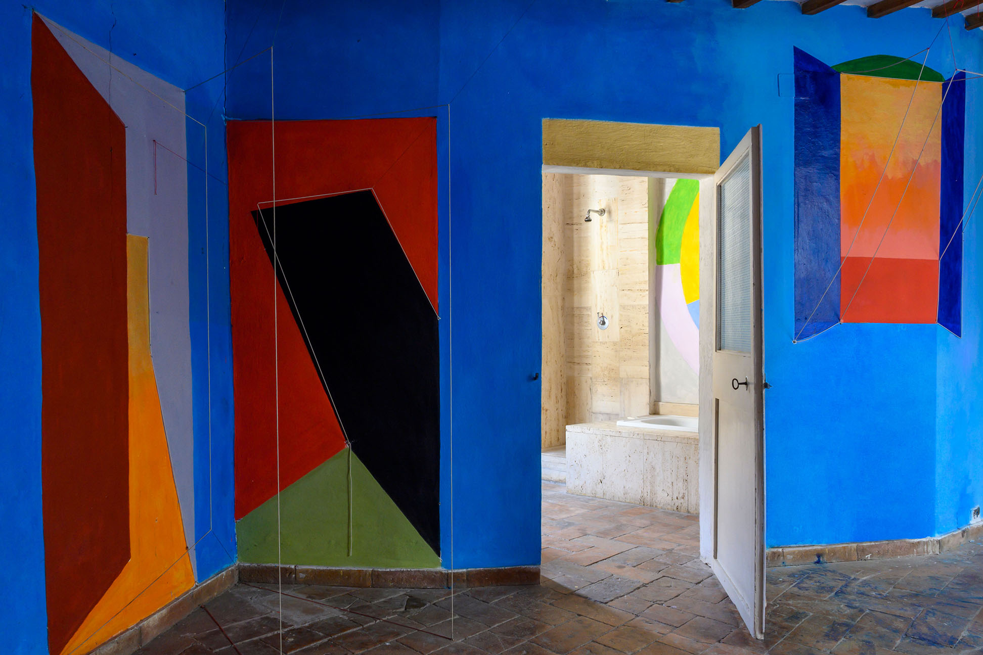 blue room with colorful wall murals