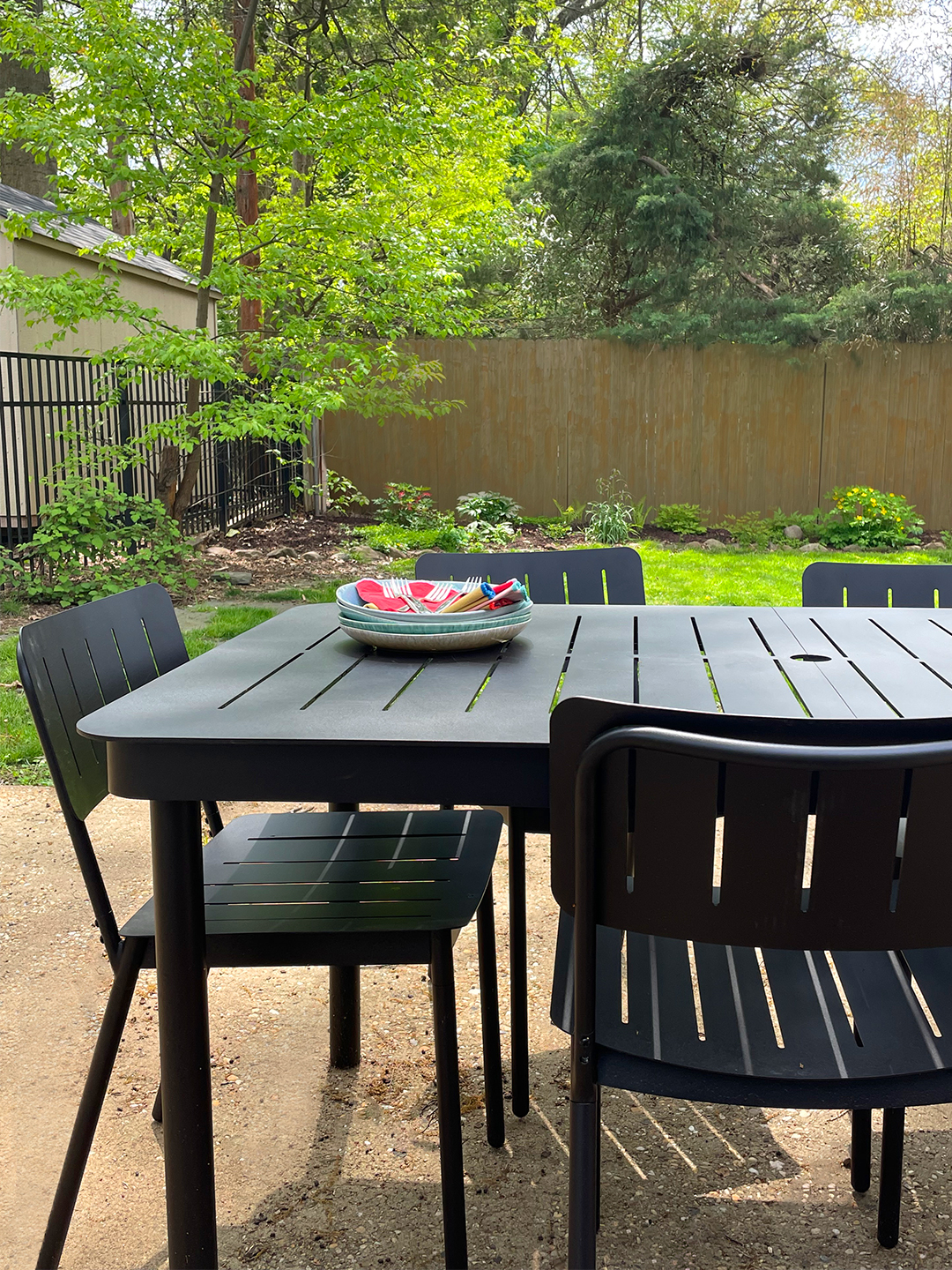 black powder-coated table and chairs in yard