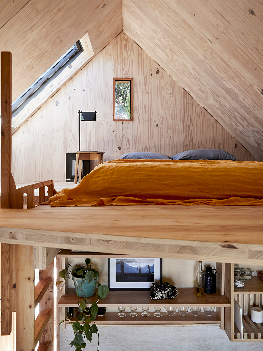 mezzanine bed with orange quilt