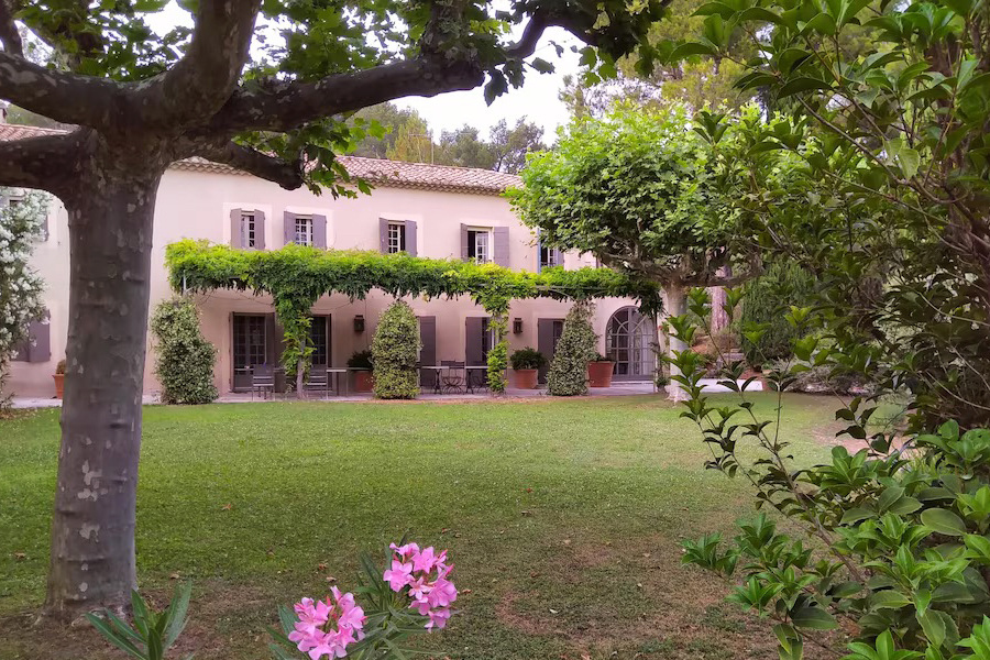 Exterior of a pink building with garden trellises