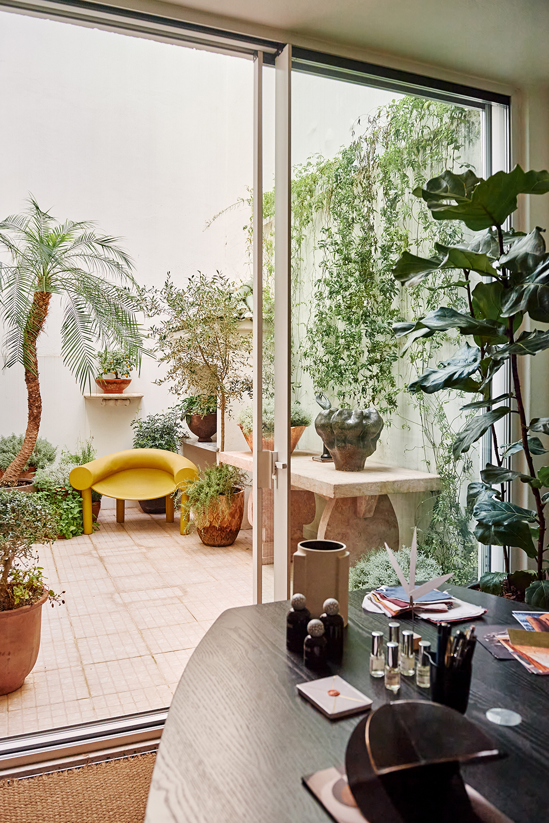 Courtyard with greenery and a yellow chair