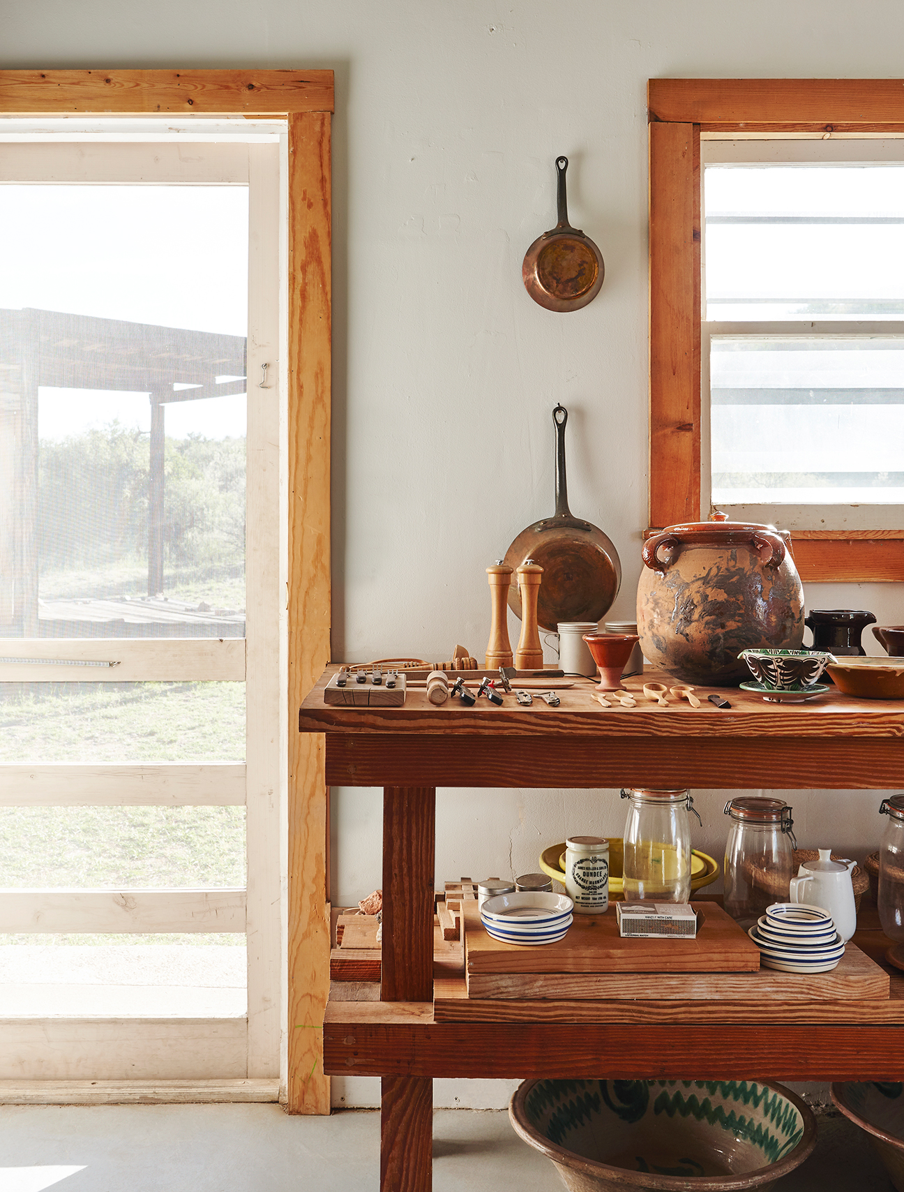 wood island with pottery