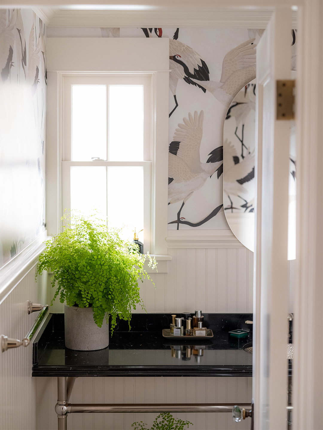 Powder room with crane wallpaper