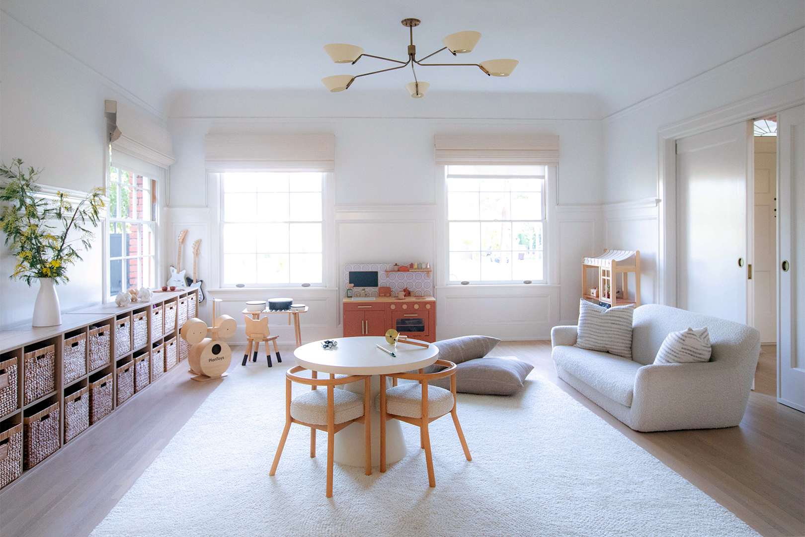 Kid's playroom with storage bins along the wall