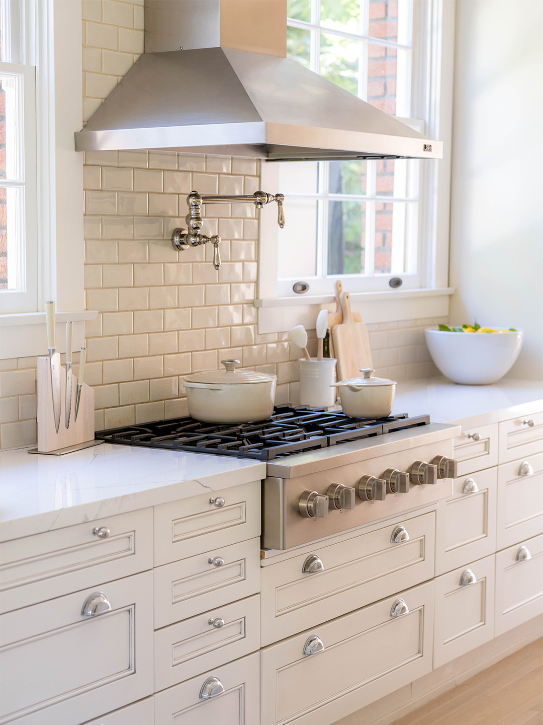 Stove surrounded by white cabinets and countertop