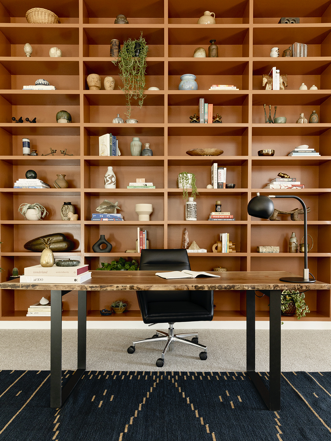 Office with a wall of wood bookshelves