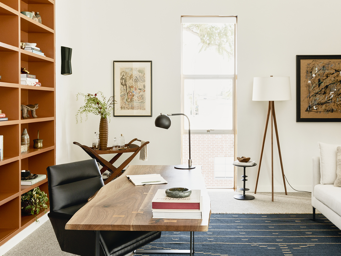 Side view of office with desk, chair and wood shelving