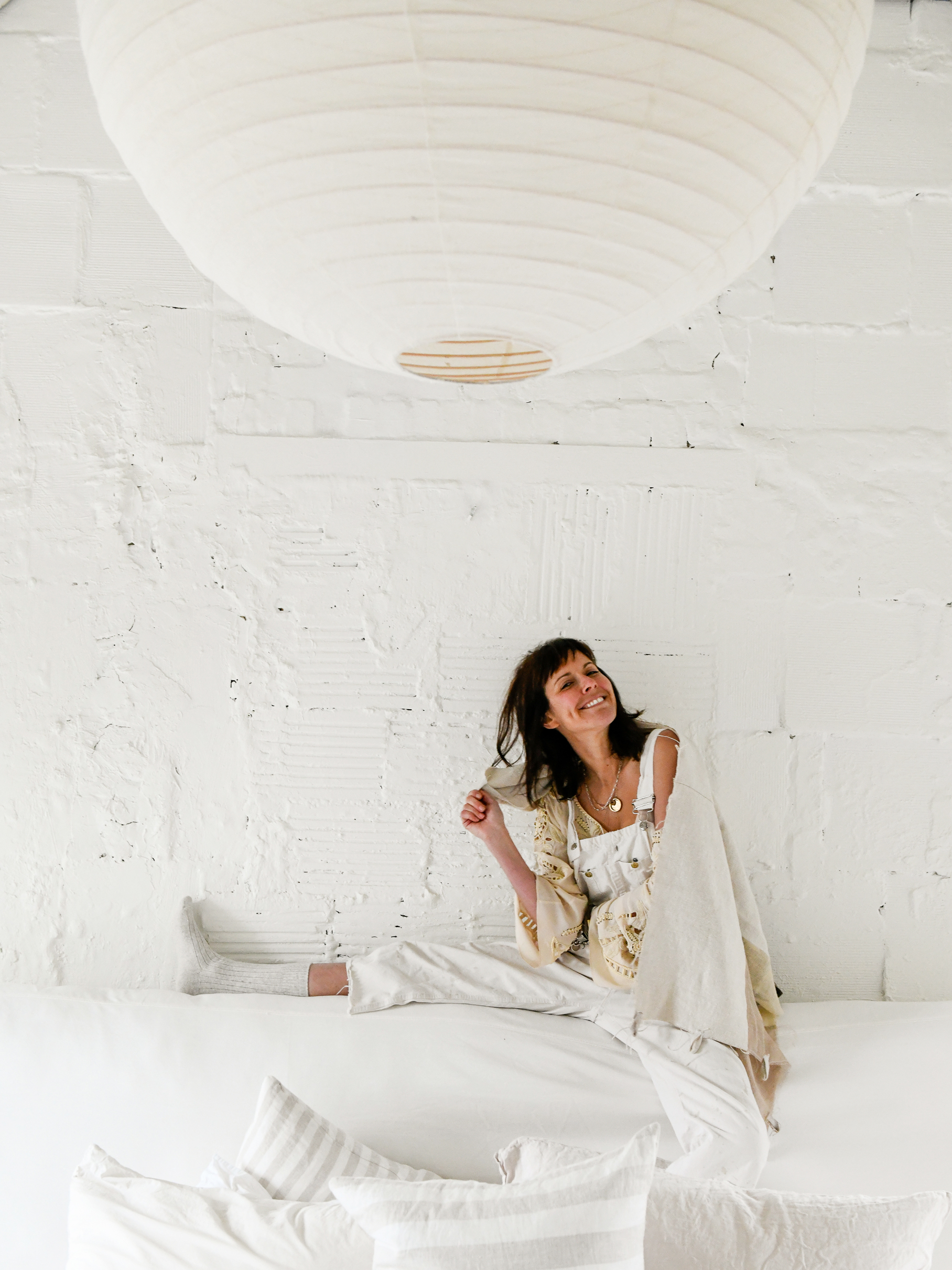 woman sitting on white ledge