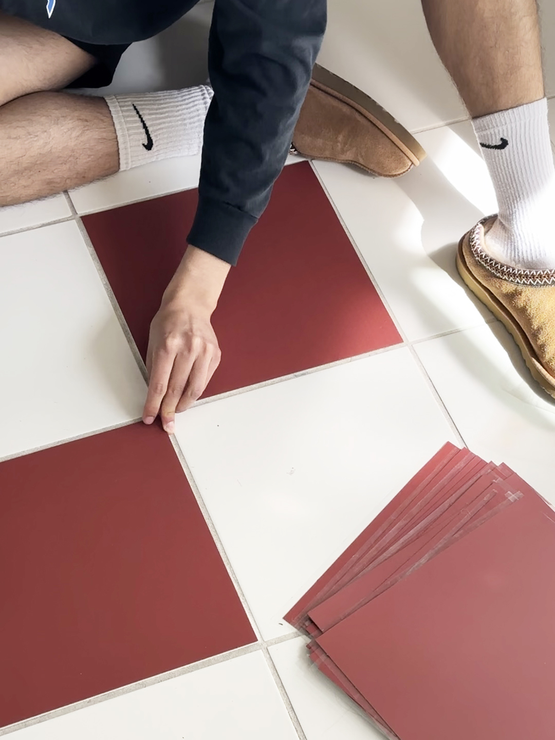 person layning checkered floors