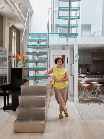 Chef Nasim Alikhani standing in front of her staircase