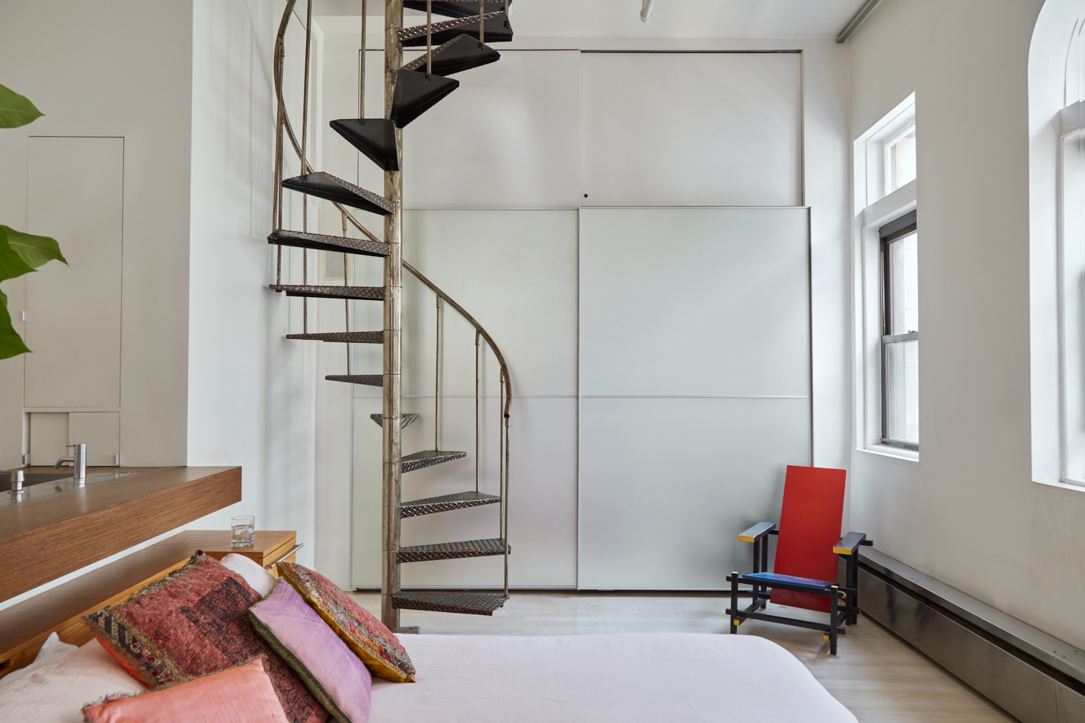 Spiral staircase in a bedroom corner