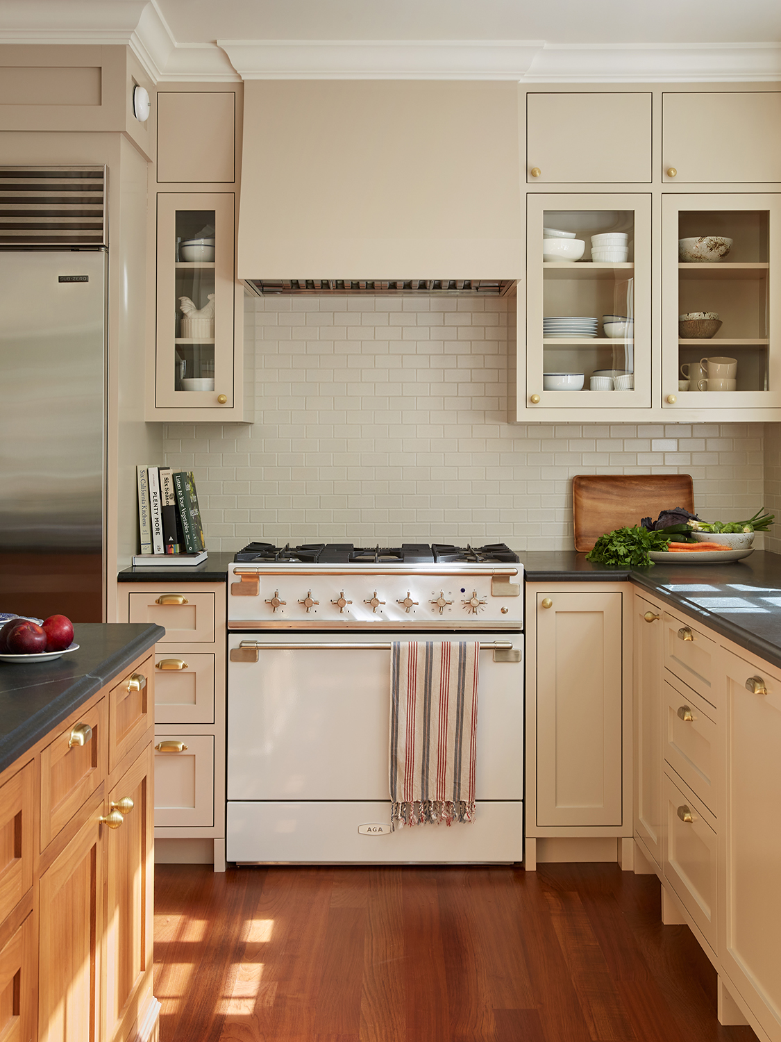 Main kitchen with cream cabinets and a wooden island