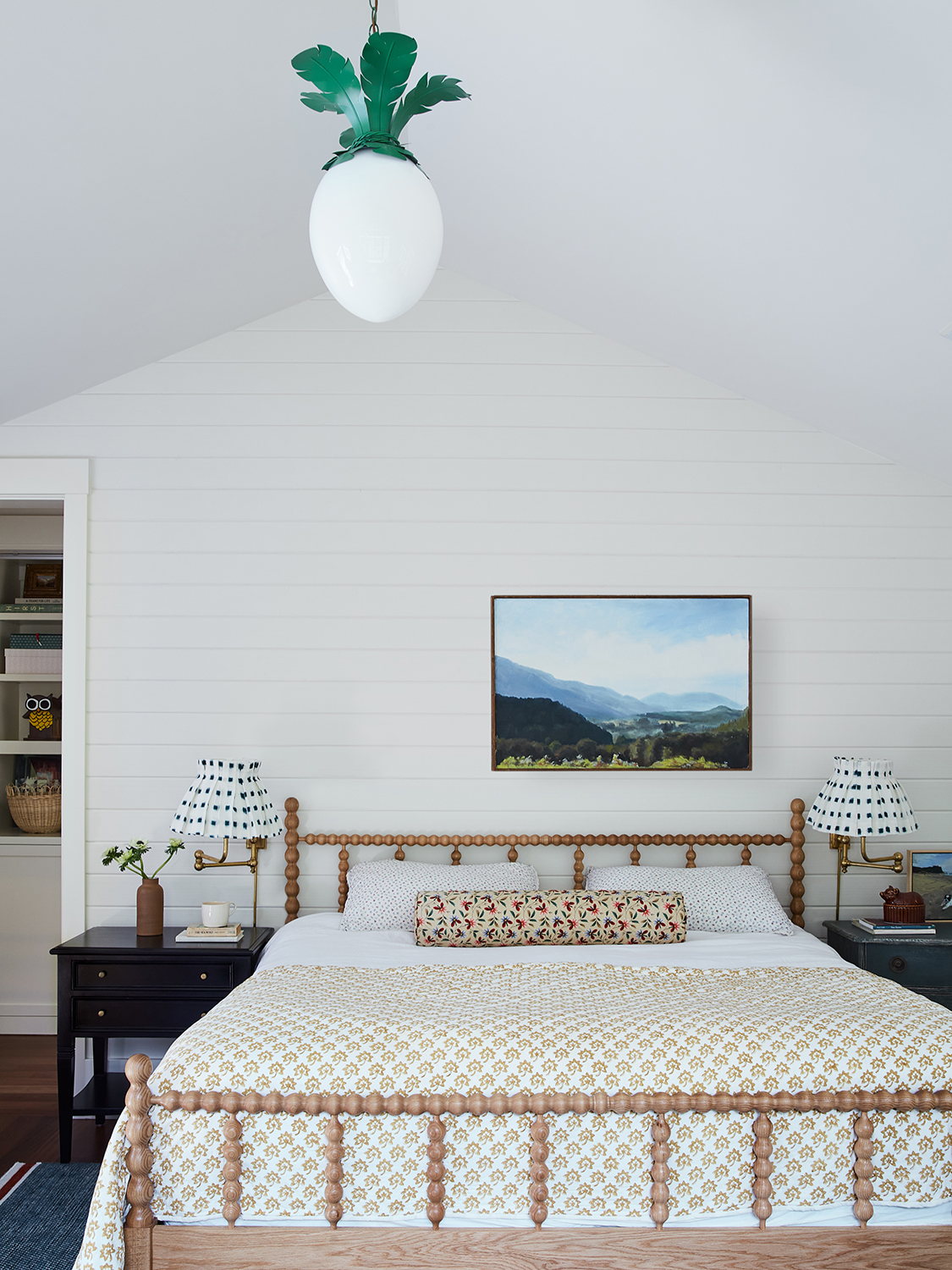 Bedroom with spindle bed and palm-leaf light