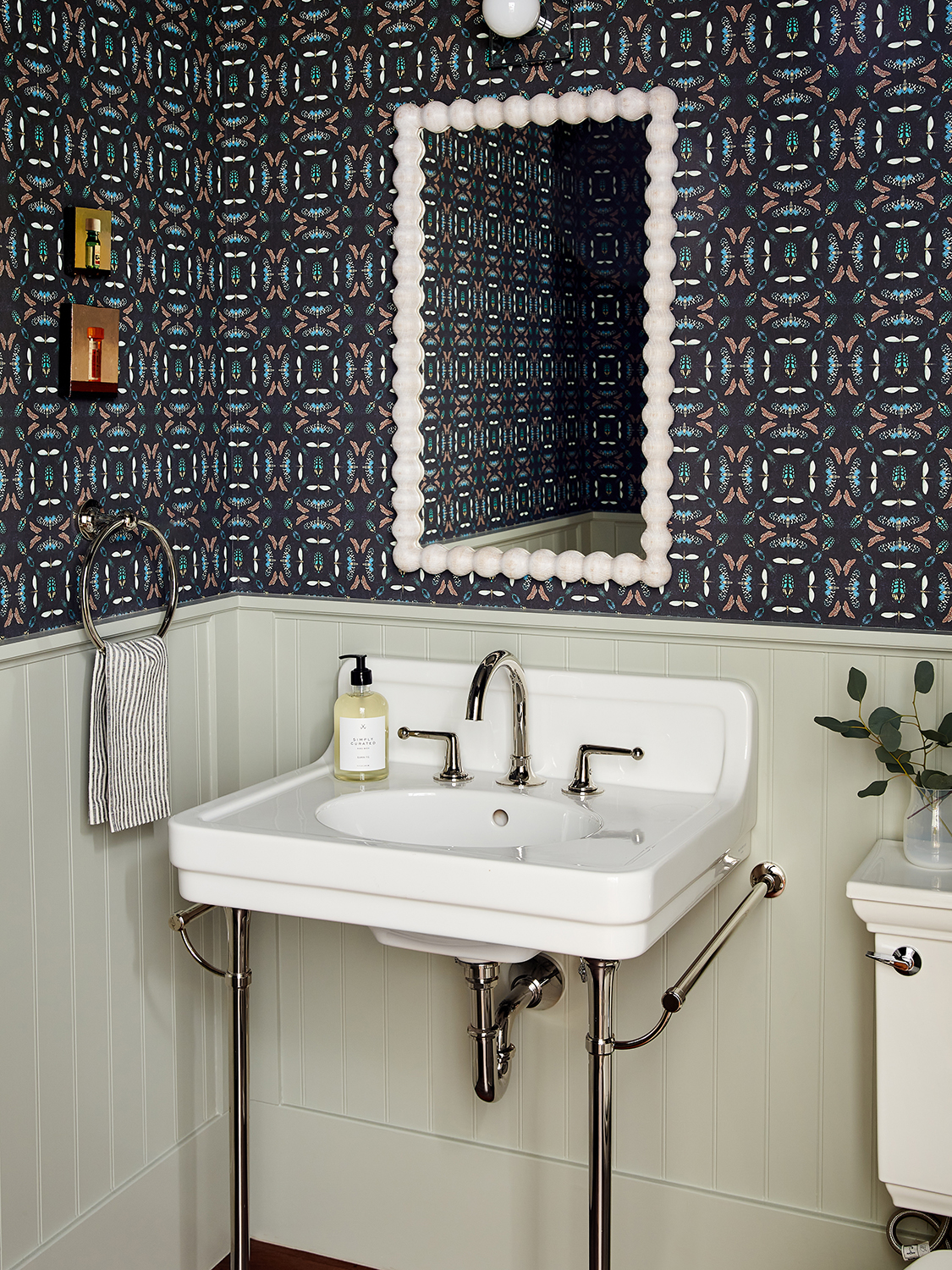 Powder room with geometric wallpaper