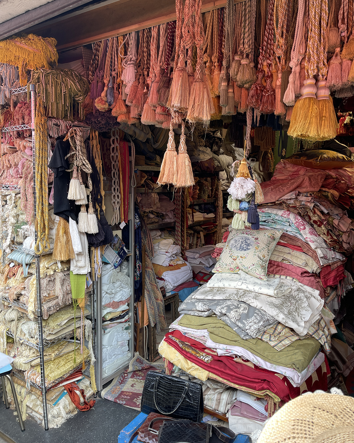 A booth fulled with linens at a French flea market