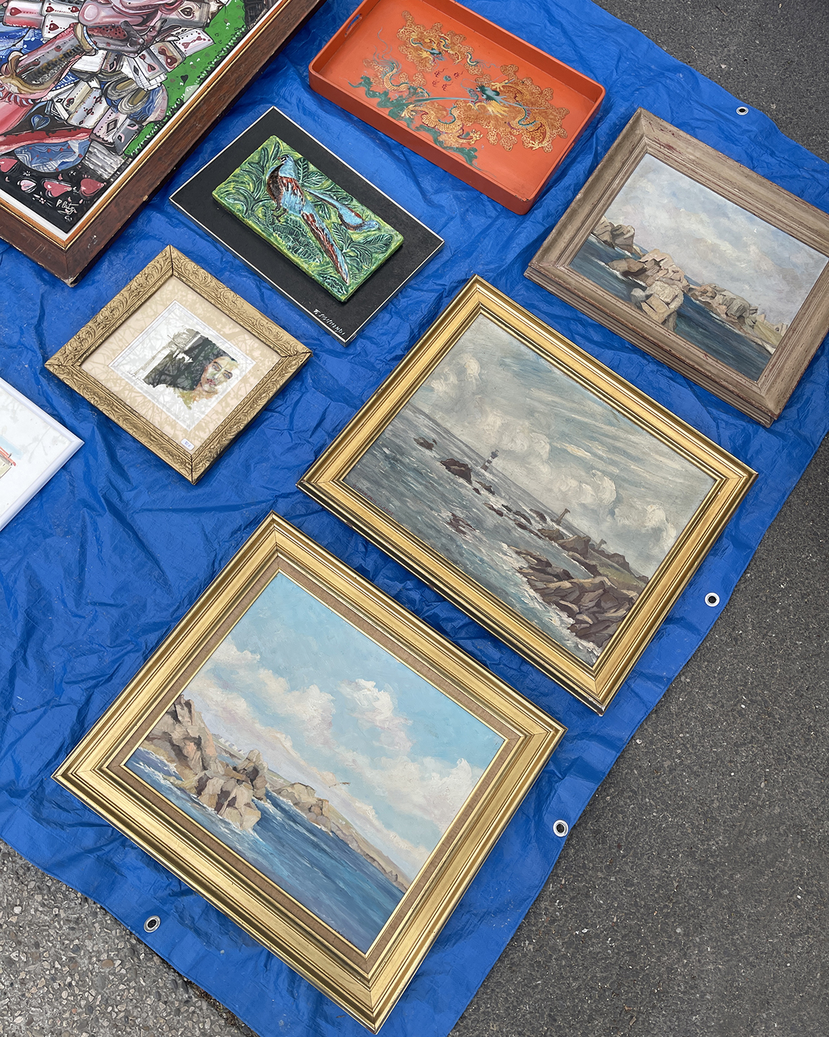 Framed artwork on a table at a flea market