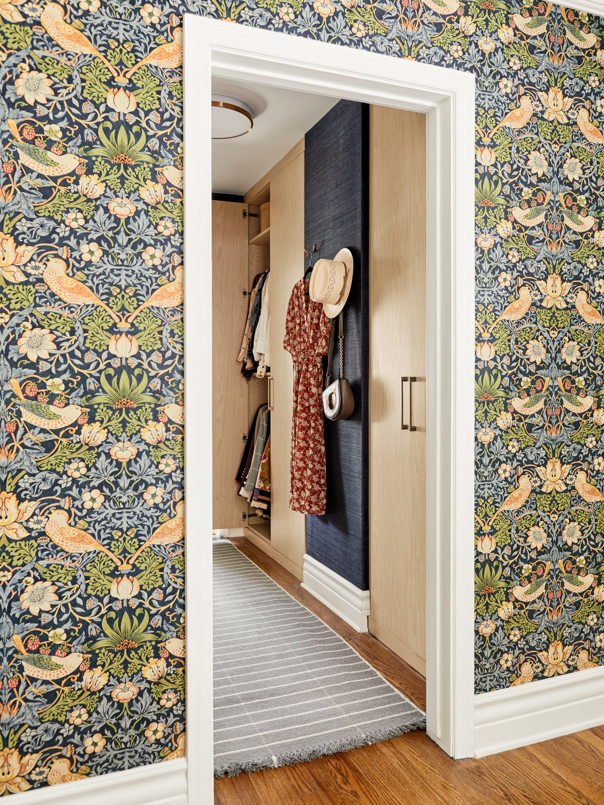 wallpapered bedroom looking into closet