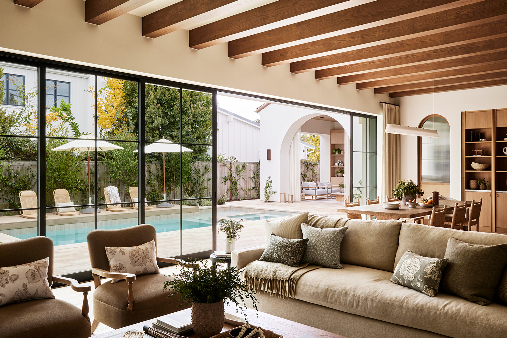 Living room with doors opening to the pool