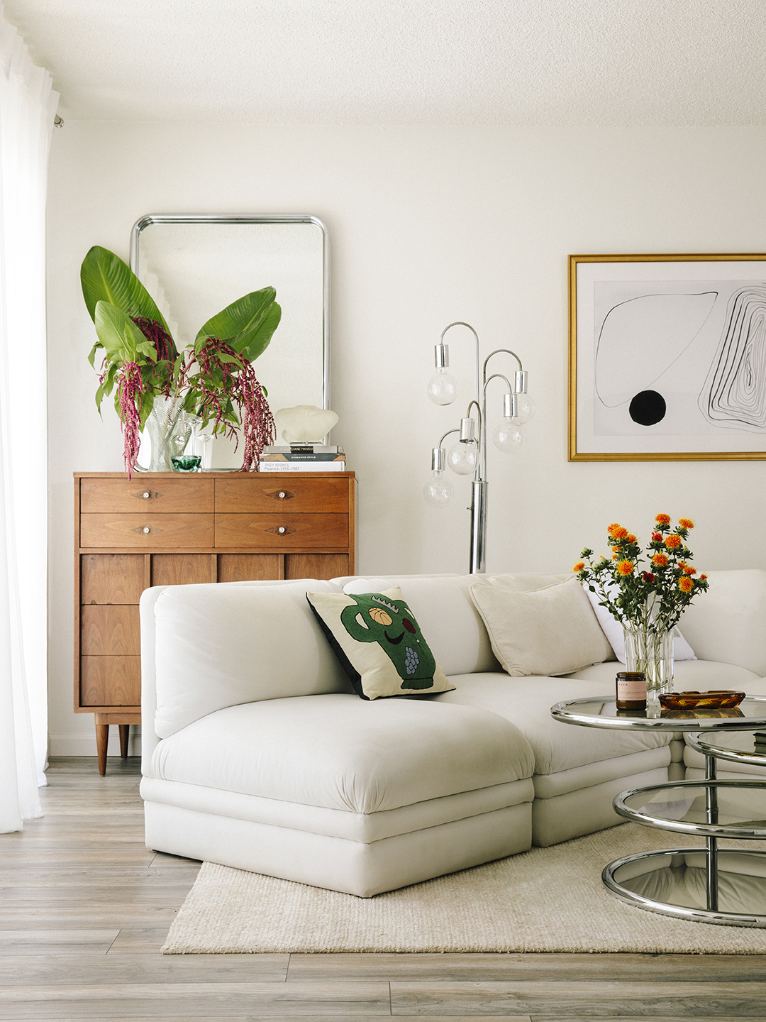 Living room with white sofa and midcentury console